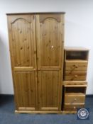 A pine double door wardrobe together with a pair of pine two-drawer bedside stands