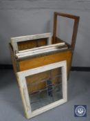 A mid 20th century trolley containing four framed stained glass windows