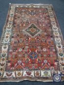 A fringed woollen Persian rug