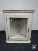 A 20th century painted glazed door corner cabinet