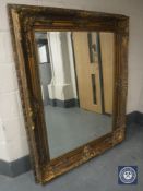 An ornate gilt bevelled overmantel mirror,