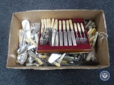 A box of assorted plated and stainless steel flatware