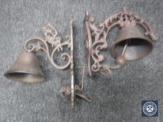 Two cast metal bells on brackets