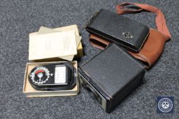 A box containing boxed Brownie camera, light meter,