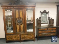 A carved walnut Victorian triple door wardrobe (width 180cm) with matching dressing table