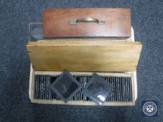 A tray of three boxes of antique glass slides