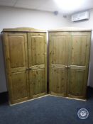 A pair of pine double door wardrobes