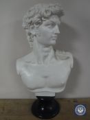 A resin bust of David on stand