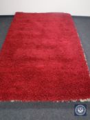 A hand knotted shaggy red rug, 180 cm x 270 cm,