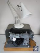A cased mid 20th century Jones electric sewing machine and an angle poised lamp