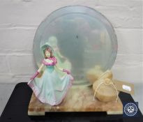 An Art Deco marble mirrored back table stand with lidded trinket pot and a figure of a lady