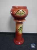 An early 20th century pottery jardiniere on stand
