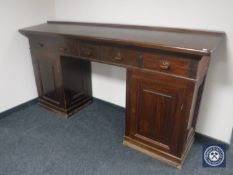 An early 20th century twin pedestal clerk's desk fitted with five drawers