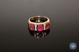 A 14ct yellow gold ruby and diamond ring, with three, central,