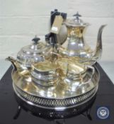 A four-piece Sheffield plated tea service on circular gallery tray