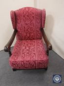 A 20th century oak framed wing back armchair