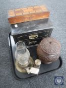 A tray of a carved hardwood lidded pot, brass oil lamp with glass chimneys,