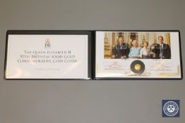 A Jubilee Mint 2016 Queen Elizabeth II Commemorative 9ct Gold Coin Cover, a limited edition of 499,