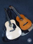 A Fender Squier acoustic guitar and another acoustic guitar,