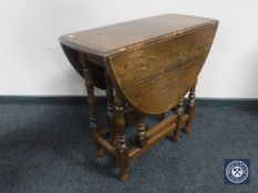 An antique oak gate leg table