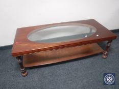A mahogany two tier coffee with inset glass panel