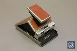 A vintage Polaroid SX-70 Land Camera CONDITION REPORT: This contains a battery but