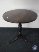 A 19th century oak pedestal occasional table