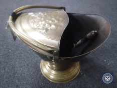 An early 20th century brass coal bucket with shovel