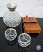 A cut glass silver lidded perfume bottle,