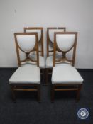 A set of four oak Arts & Crafts dining chairs