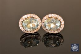 A pair of 14ct yellow gold aquamarine and diamond earrings, the two oval-cut,