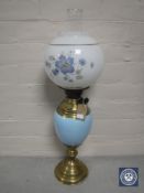 A Victorian brass and china oil lamp with glass chimney and shade
