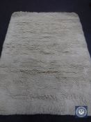 A hand tufted shaggy cream rug, 160 cm x 230 cm,