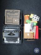 A cased Olympia typewriter and a box of maps,