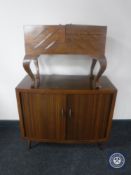 A mid 20th century sewing box and a walnut shutter door cabinet