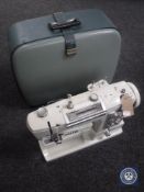 A cased Jones Deluxe electric sewing machine in accessories