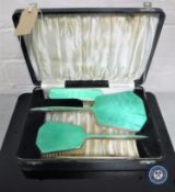 A cased three-piece silver and enamelled dressing table set