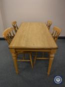 A kitchen table and four pine chairs