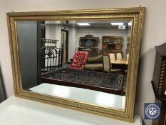 A gilt-framed bevelled mirror,