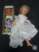 A box of mid 20th century doll in white dress and a boxed Pelham puppet