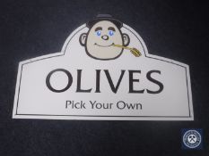 Two classic car posters and a Pick Your Own Olives sign