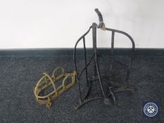 Two cast metal saddle racks