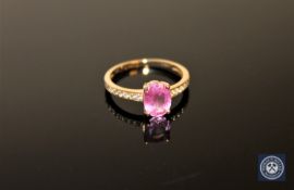 A 14ct yellow gold sapphire and diamond ring, an oval-cut pink sapphire weighing 1.