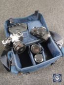 A camera bag containing an Olympus OM4 and OM10,