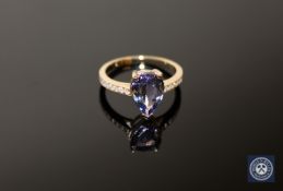 A 14ct yellow gold tanzanite and diamond ring, a pear-cut purplish-blue tanzanite weighing 2.