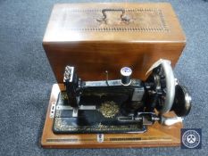 An inlaid mahogany cased German hand sewing machine