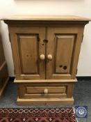 A pine double door cabinet,