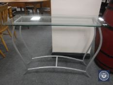 A metal and glass topped side table