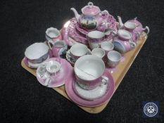 A tray of twenty-nine pieces of early 20th century lustre tourist china
