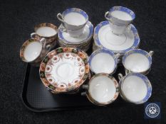 A tray of two china part tea services